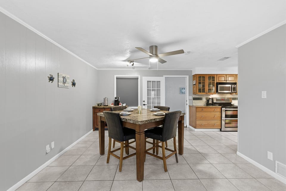 Gather in this inviting beach stay dining area with seating for meals and quick access to the fully equipped kitchen—perfect for enjoying home-cooked dinners after a relaxing day at the beach.