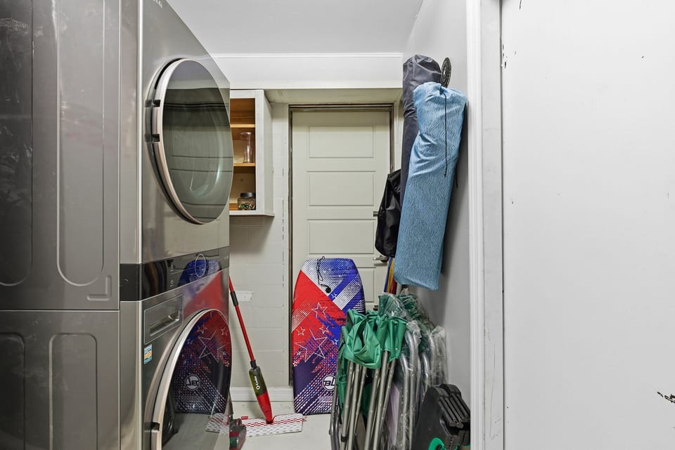 Convenient beach stay laundry area with washer, dryer, and space for beach gear—perfect for keeping everything clean and organized after a fun-filled day by the shore.