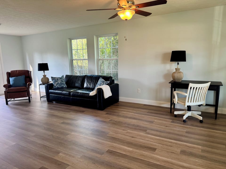 Family room area located on main floor with TV and dedicated work space.  