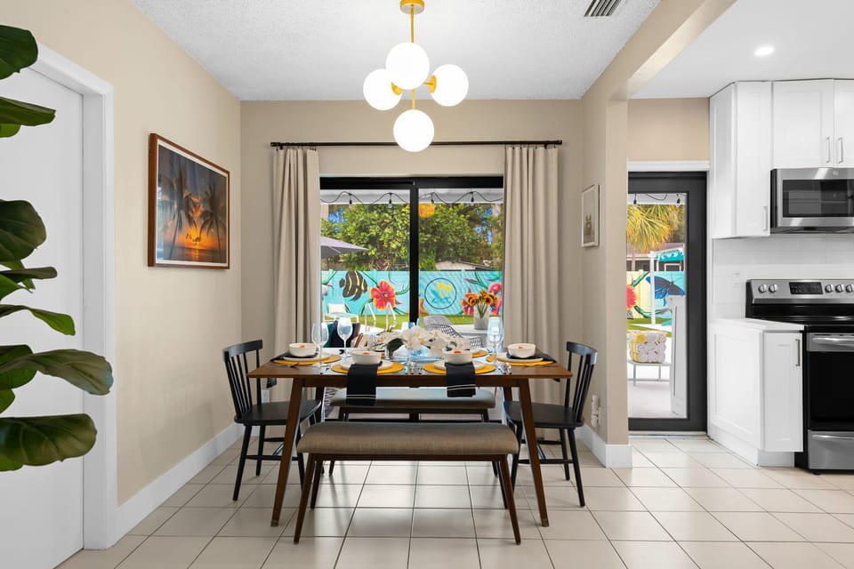 Bright, open dining area with solid wood table, chairs & benches.
