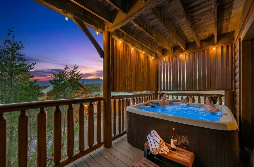 Your evening starts here — covered hot tub, Smoky Mountain sunset, and nowhere else you need to be. Pool towels provided for every guest.
