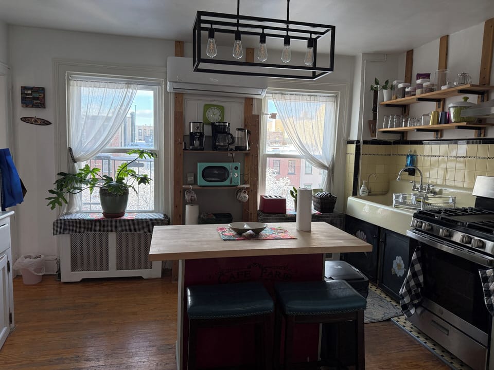The kitchen featuring gas stove and full fridge