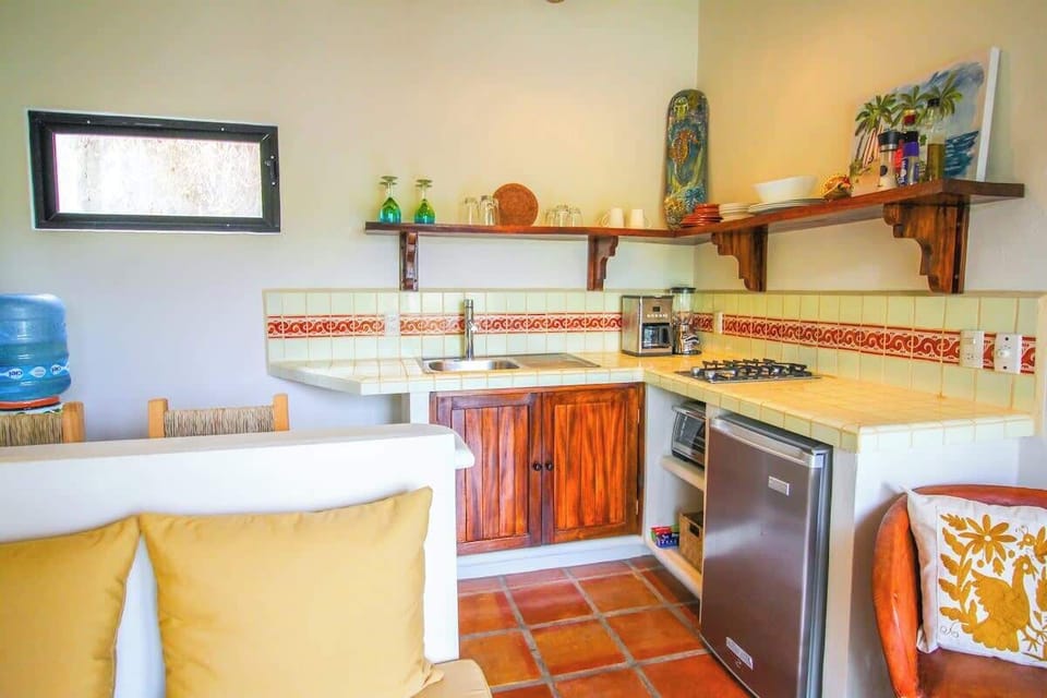 Living room with sofa, breakfast bar and kitchenette with all essentials.