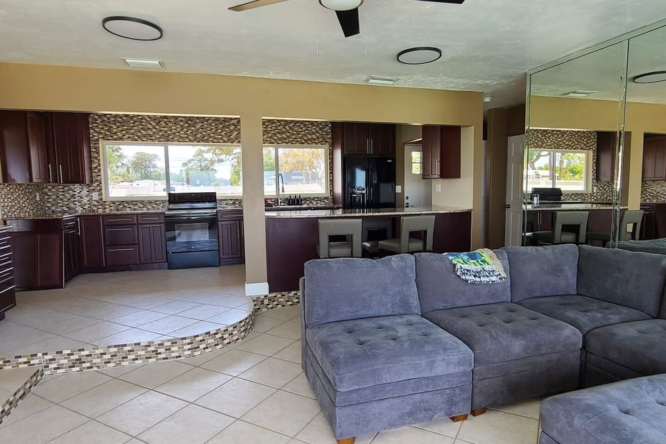 Open-concept living at its finest. Our spacious lounge flows seamlessly into the kitchen, ensuring you never miss a conversation—or a glimpse of the lagoon—while preparing a meal or relaxing by the full-wall windows