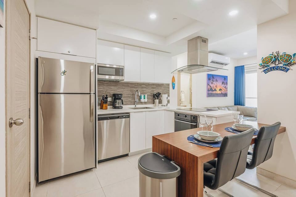 This open-concept space showcases the kitchen alongside the dining and living areas, ideal for shared moments and effortless entertaining.