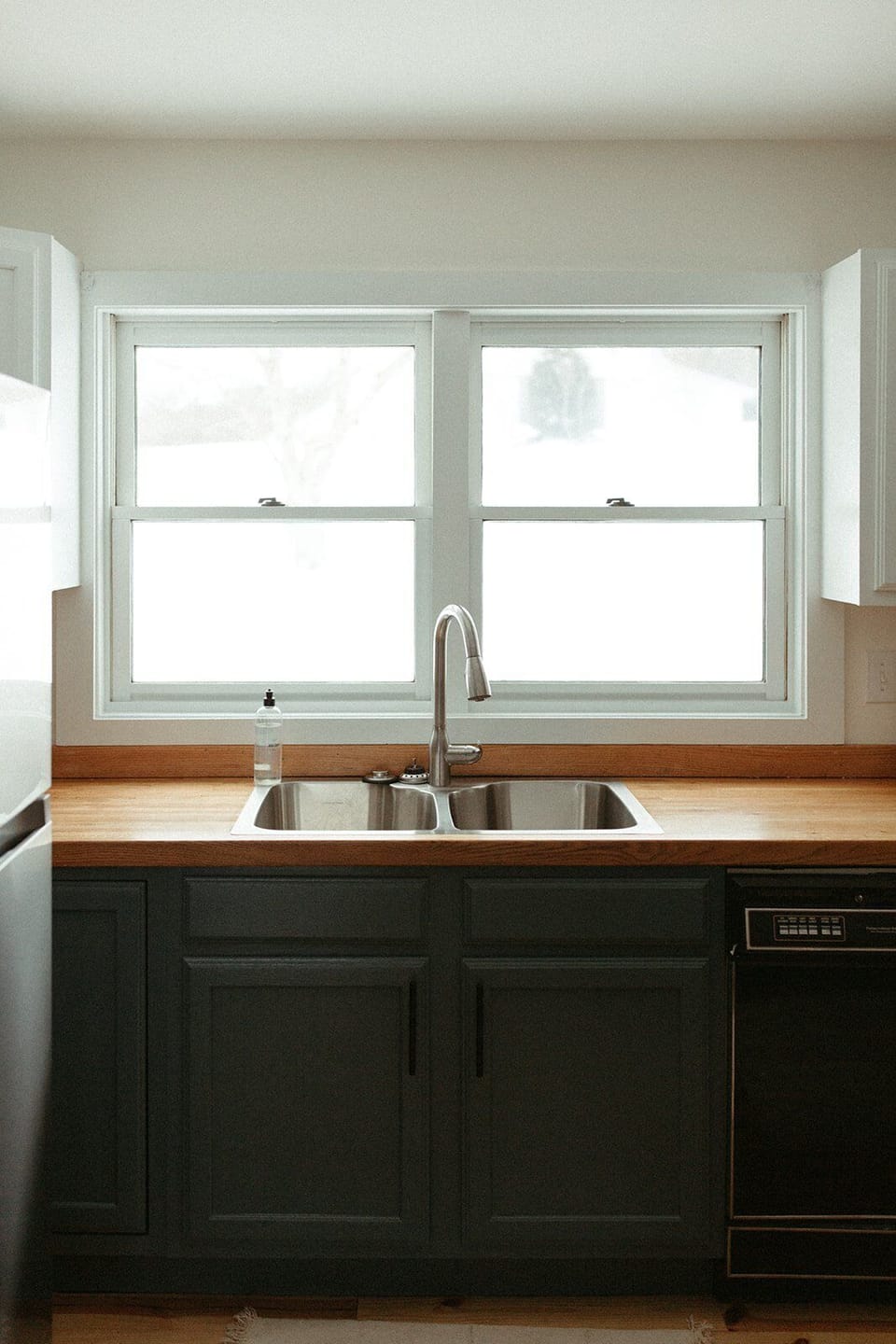 Main floor kitchen sink with big windows and natural light, great for prep and clean-up.