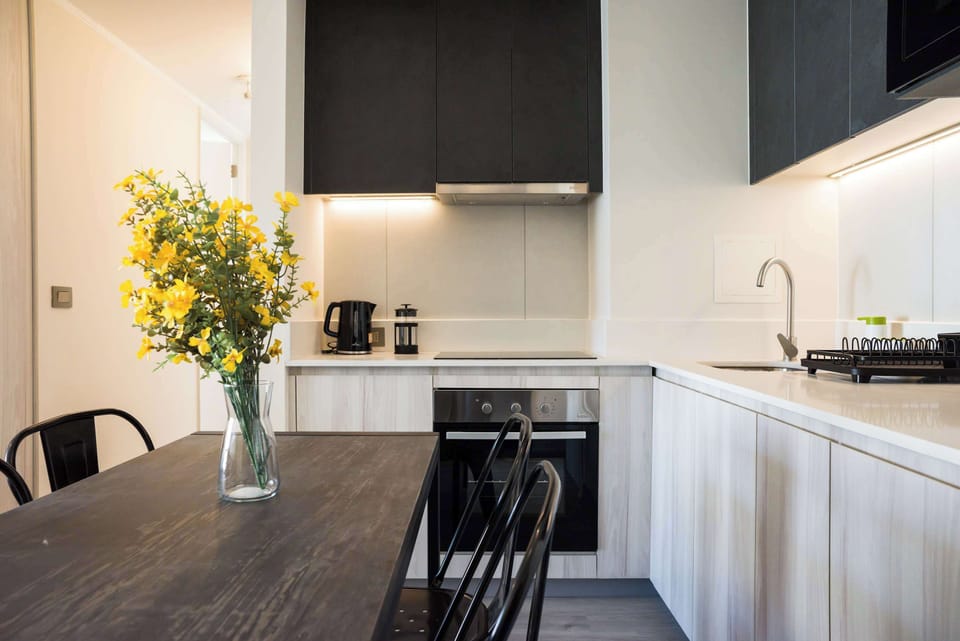 Modern kitchen with sleek design and vibrant decor, ideal for culinary enthusiasts.