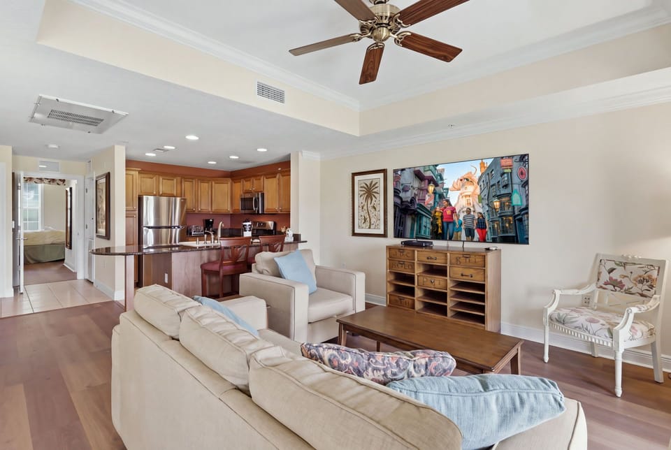 Sunlight fills the spacious living room, with French doors leading directly to the covered patio and beautiful resort views.