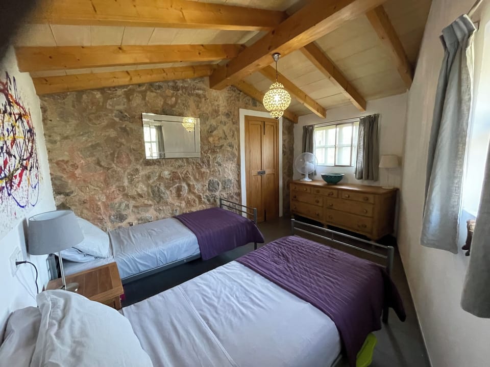 Bedroom 2 dual aspect with views to the Tramuntana Mountains and across the vill