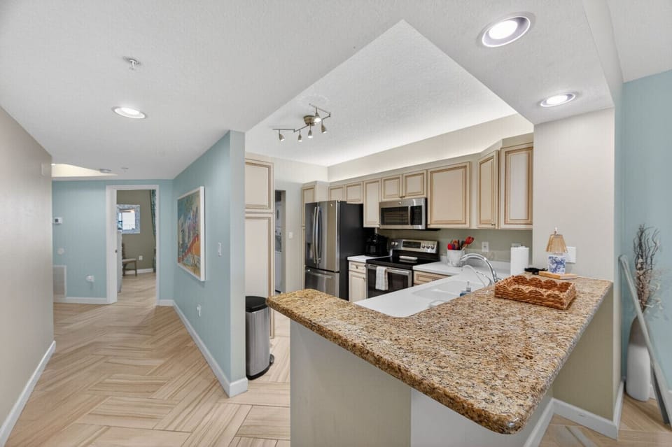 Open kitchen & living area w/ breakfast bar, flowing easily into the main space.