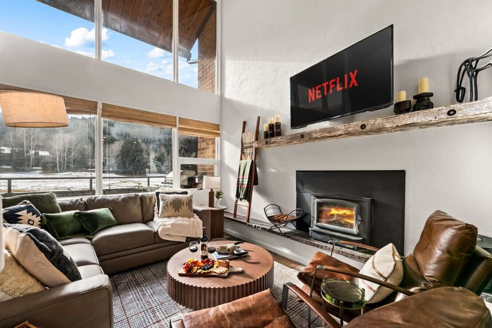 Bright and spacious living room with floor to ceiling windows and golf course views