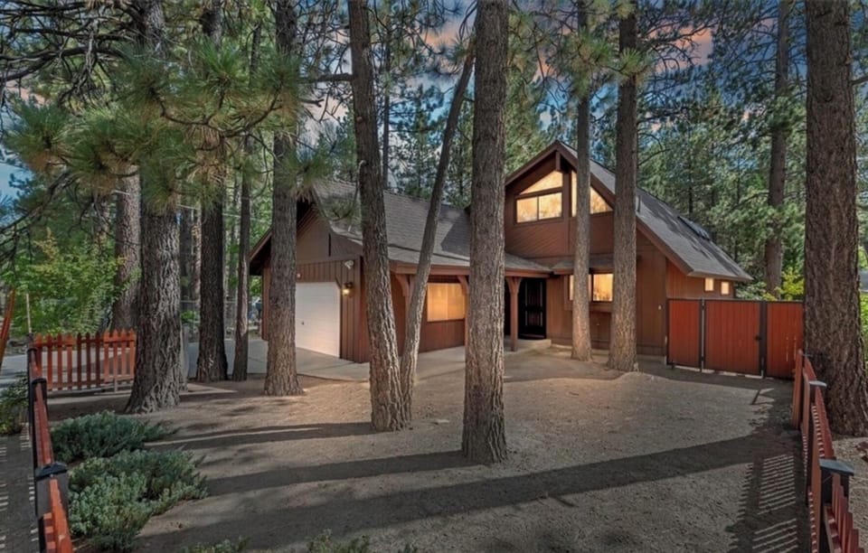 Exterior front of home nestled among the pines.