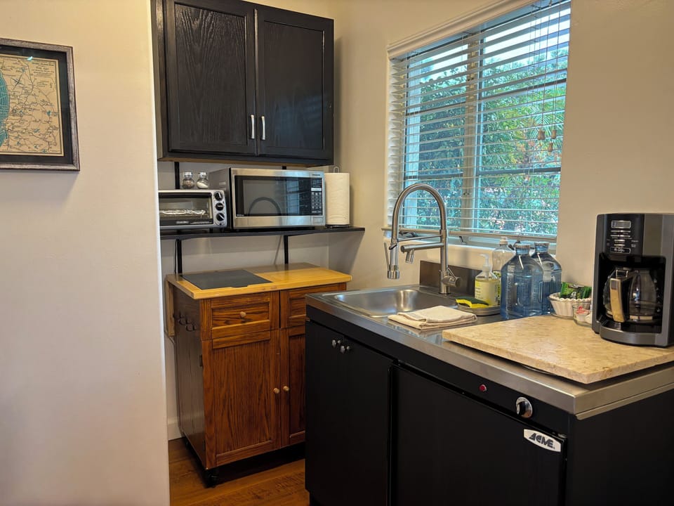 Kitchenette with microwave, coffee maker, & fridge — no burners.
