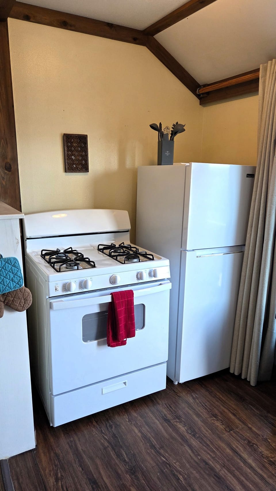The kitchen has a refrigerator/freezer, stove, microwave, and coffee maker.