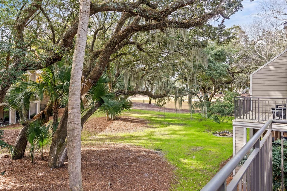 Nestled in amongst the live oaks with distant views of Ocean Winds golf course
