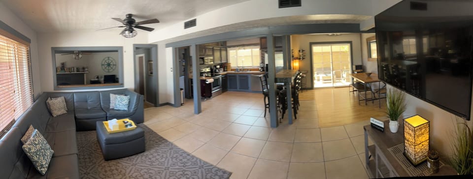 Full shot of living room, kitchen, den on left, dining on right