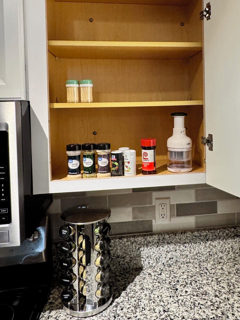 Seasoning/Spice rack with additional spices and veggie chopper in cabinet