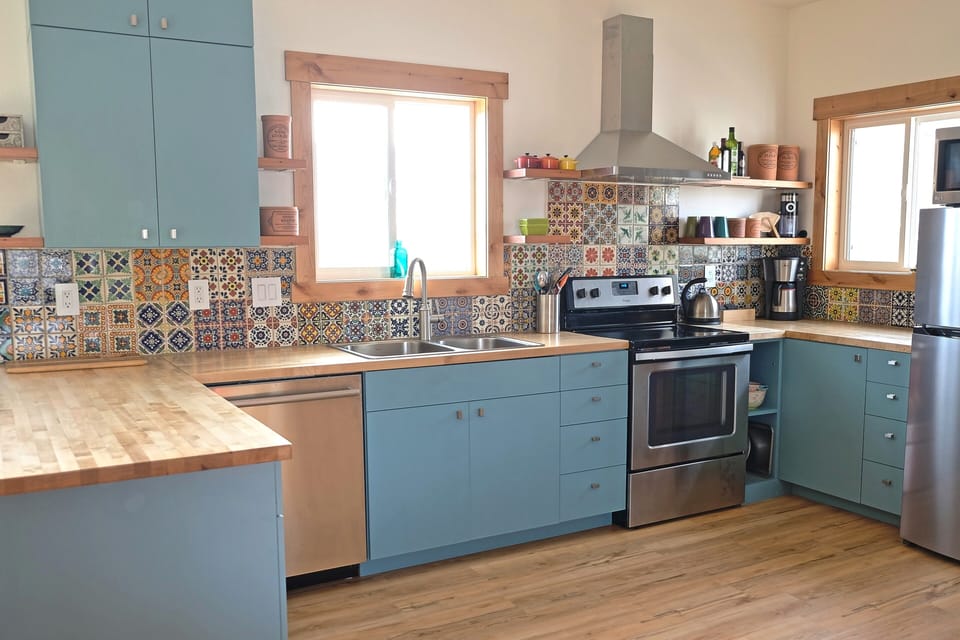 The kitchen is equipped with a full-sized stove, dishwasher, and refrigerator.