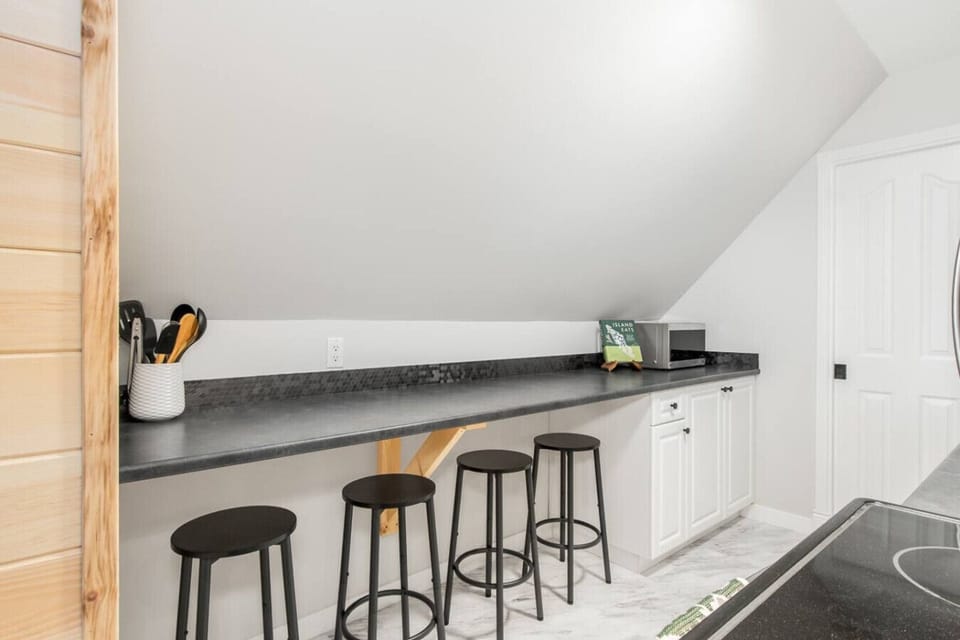 Spacious kitchen bar with seating for four, perfect for casual dining or working remotely.