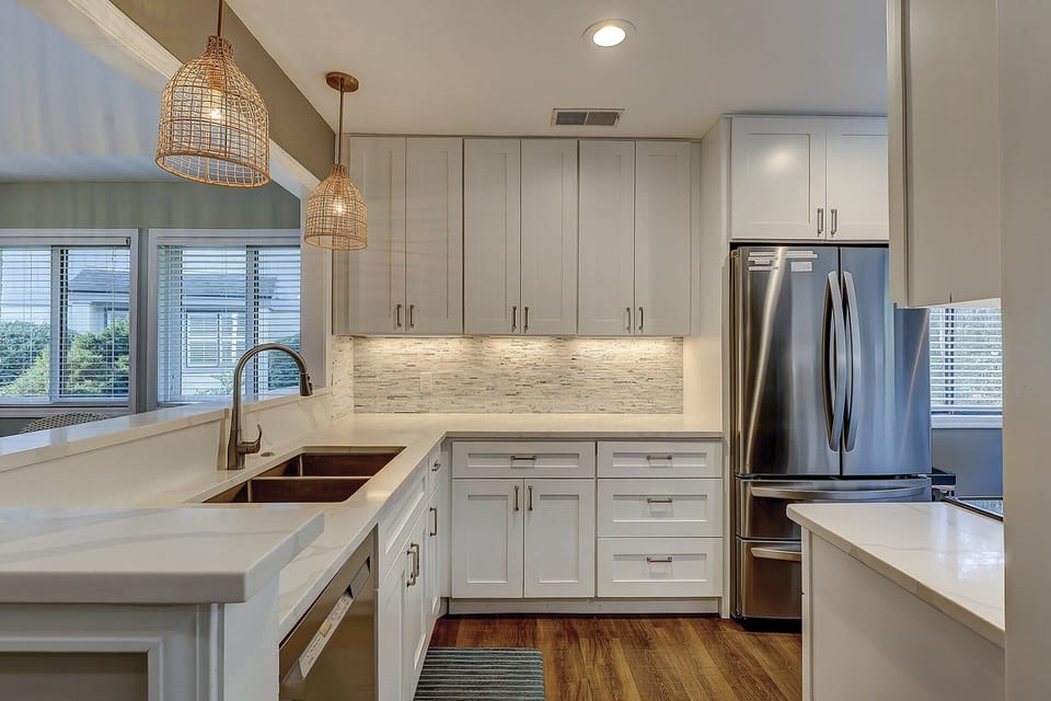 Fully stocked kitchen with stainless steel appliances.