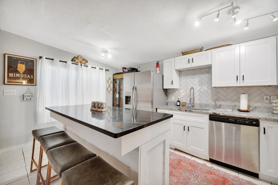 Modern kitchen with island seating and stainless appliances