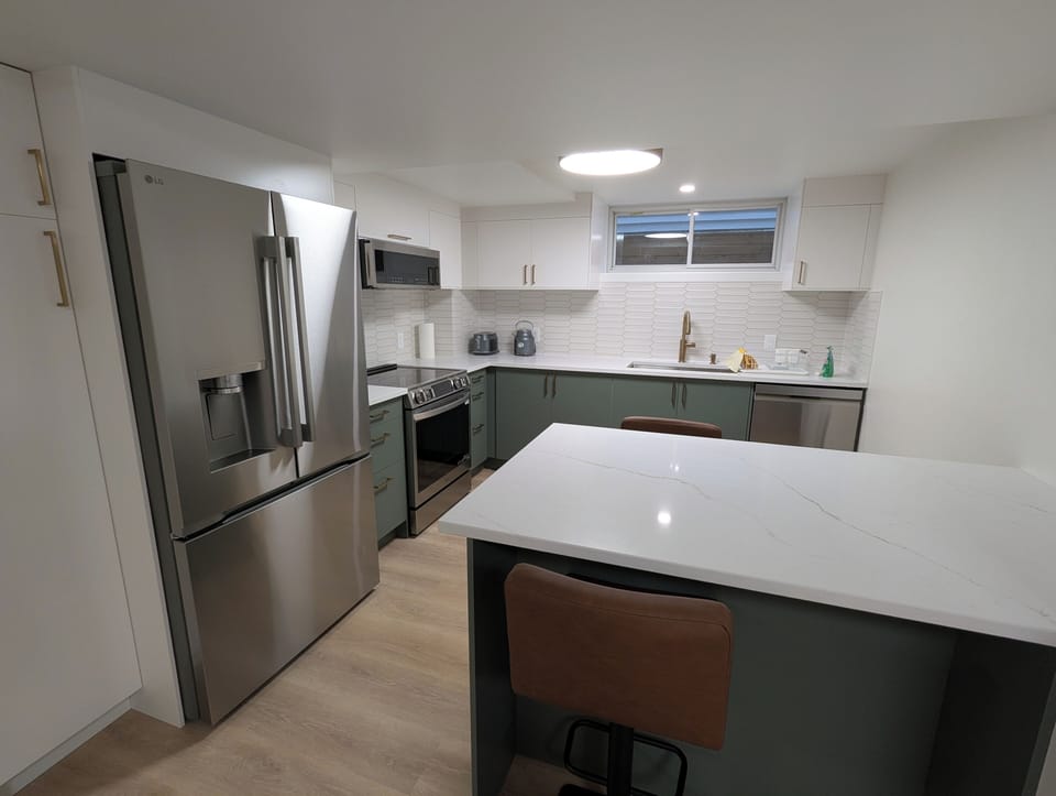 Full kitchen with induction range, oven, large refrigerator with filtered water