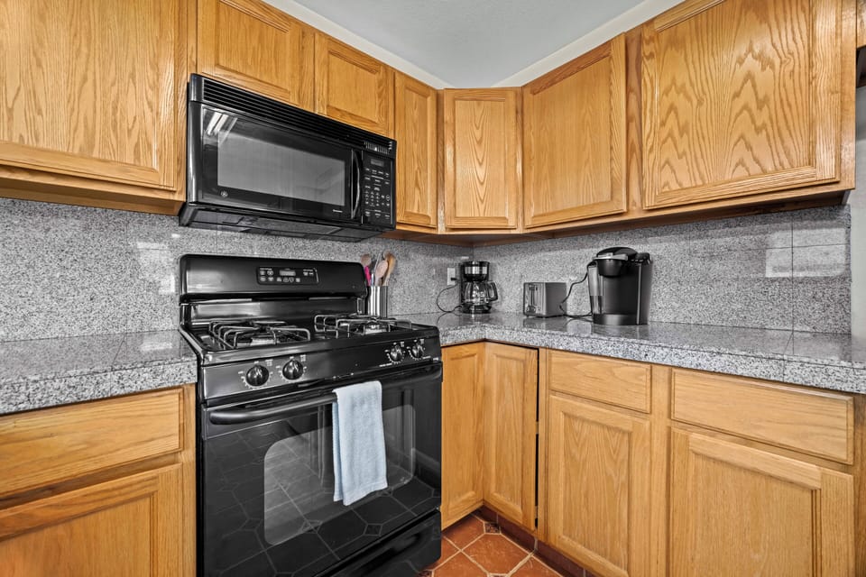 The full-size stove, microwave, and practical cooking setup is designed for easy home cooking