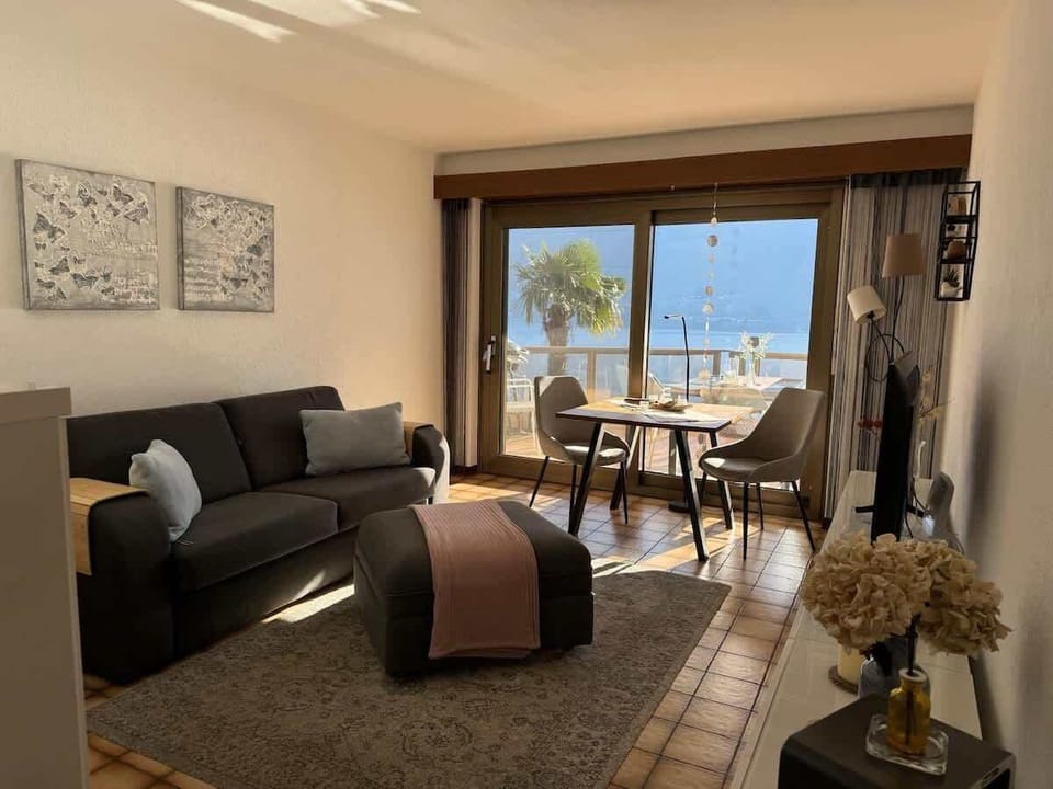 Bright studio living area with seating, dining space, and lake views