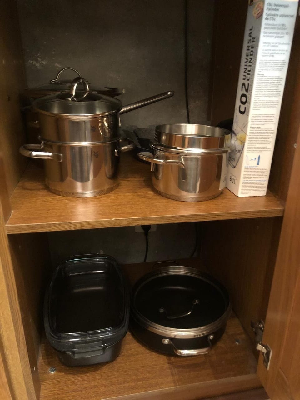 Kitchen cupboard with small appliances and cookware