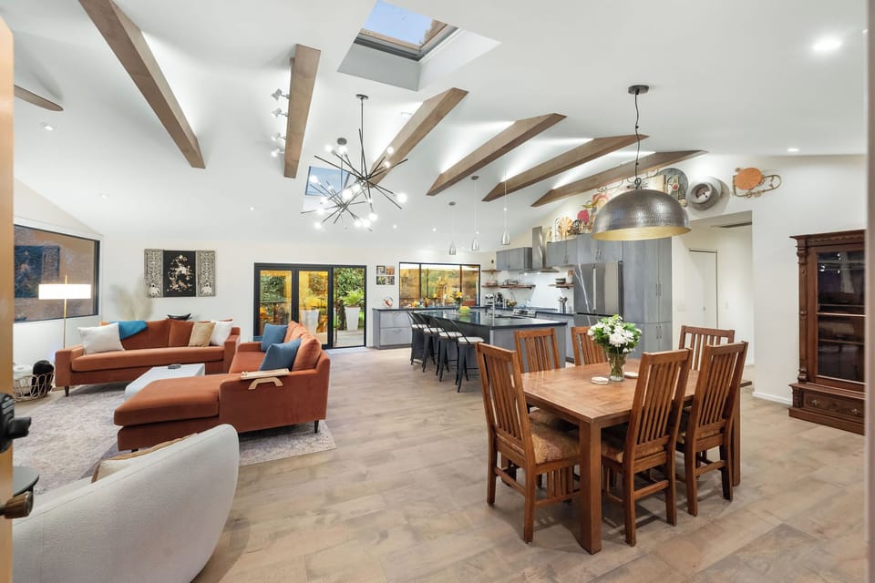 Relax in your spacious open-plan living area with vaulted ceilings, exposed beams, and skylights that fill the space with natural light.