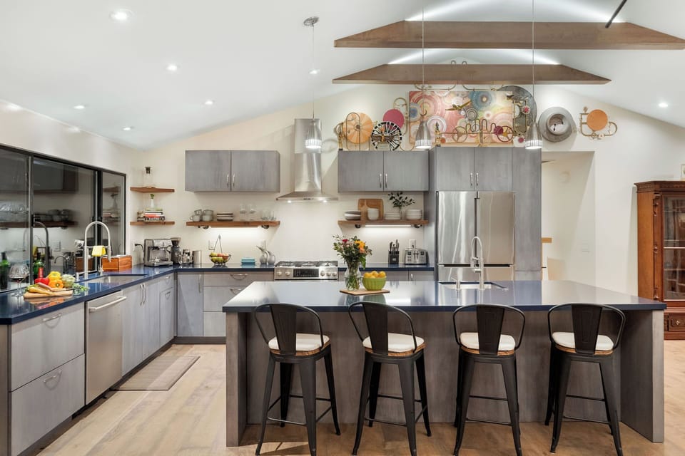 Your spacious chef's kitchen awaits with gleaming countertops, professional appliances, and a breakfast bar perfect for morning coffee conversations.