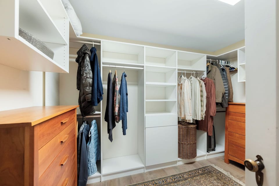Your spacious walk-in closet offers abundant storage with custom shelving and hanging space for all your belongings.