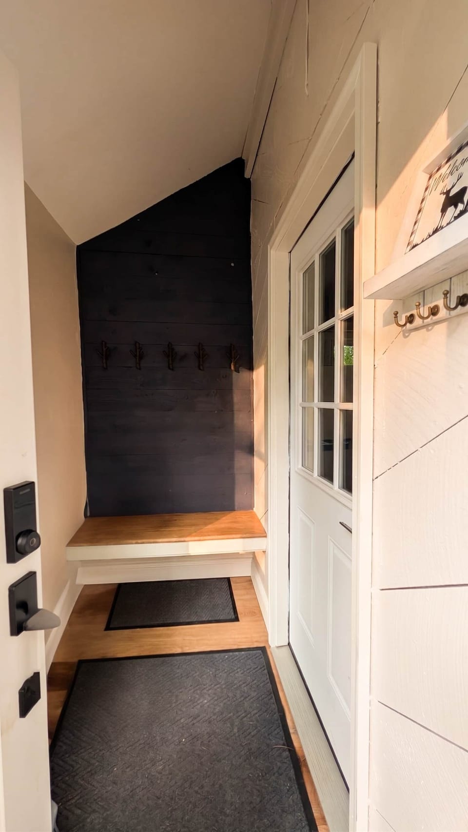 Convenient mudroom with bench seating and hooks for coats and gear.