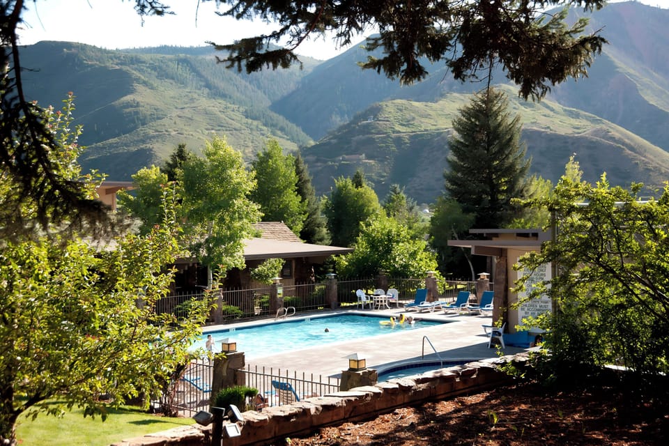 Unwind poolside beneath shady trees and stunning peaks.