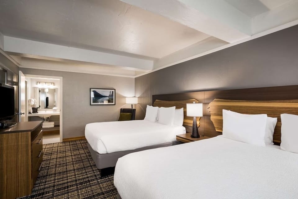 Sleep soundly with two plush beds and soft, layered lighting.
