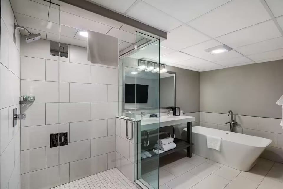 Indulge in a deep soak beside a sleek glass shower.