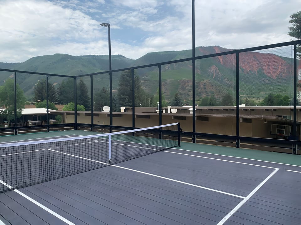 Serve up sunrise matches with sweeping mountain views.