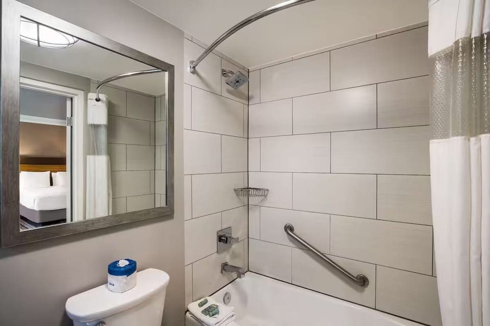 Refresh with a hot shower in a bright, tiled bath.