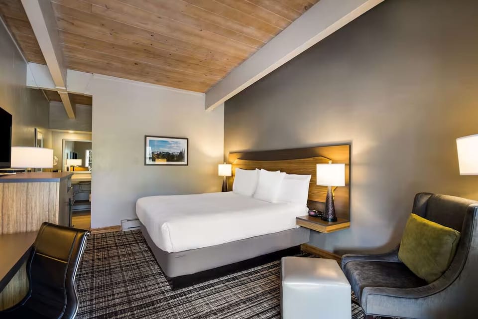 Relax in a comfy chair beside your inviting king bed.