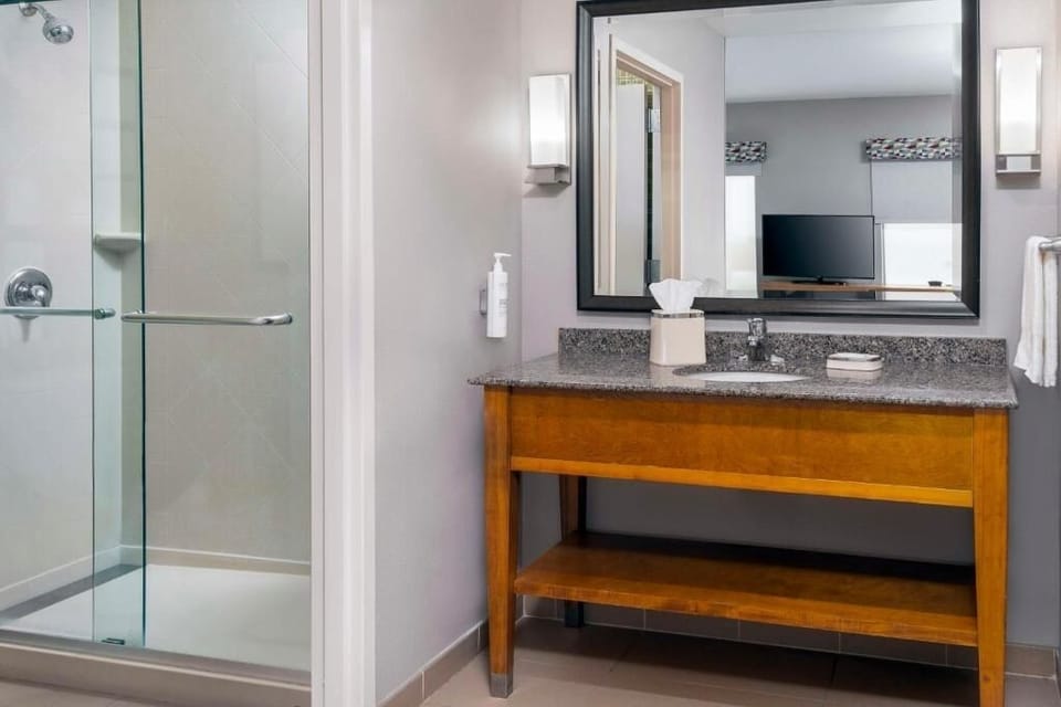 Refresh in the bright, spotless bathroom with glass shower.