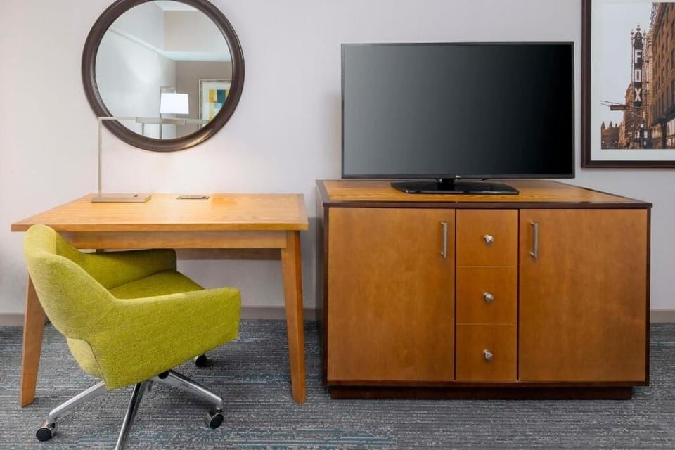 Work comfortably at the desk with TV and storage nearby.