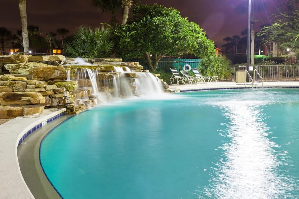 Soak in evening calm as the waterfall glows softly.
