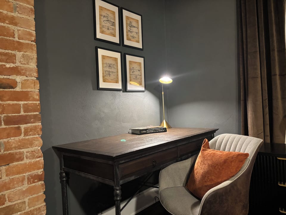 Find your focus in our Dedicated Workspace, featuring a quiet desk, comfy chair,