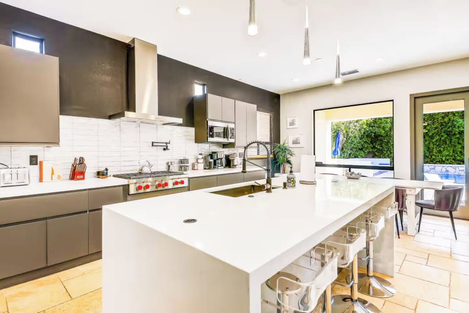 Bright, stylish kitchen with a large island, modern appliances, and plenty of seating for guests.