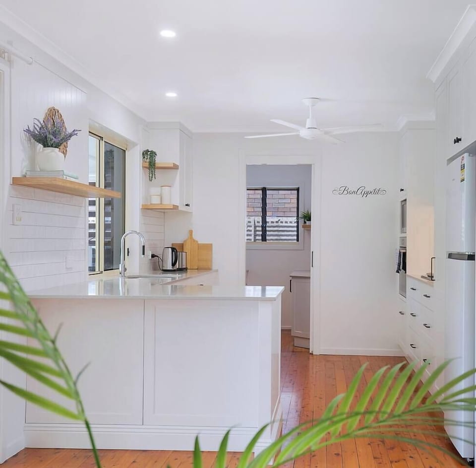 A bright, well-equipped kitchen with generous bench space and modern appliances makes everything from quick breakfasts to relaxed, shared dinners feel effortless.