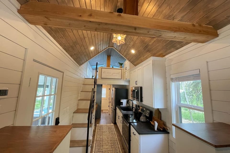 Front to back, this tiny house is only 600 square feet, but it boasts a full bathroom, kitchen, dining space, and loft bedroom!