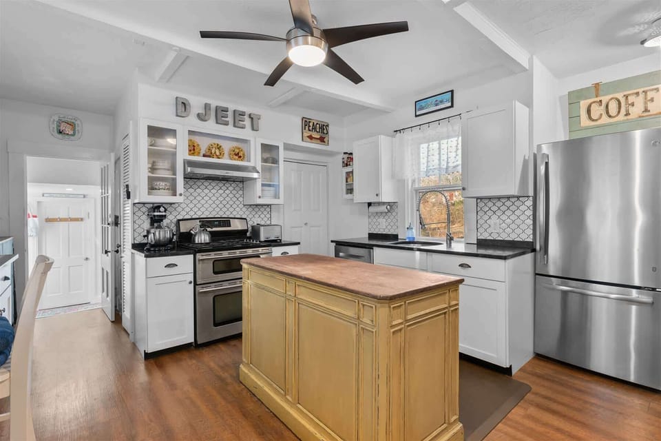 Kitchen island with bar seating for coffee, snacks, and casual conversation during your stay.