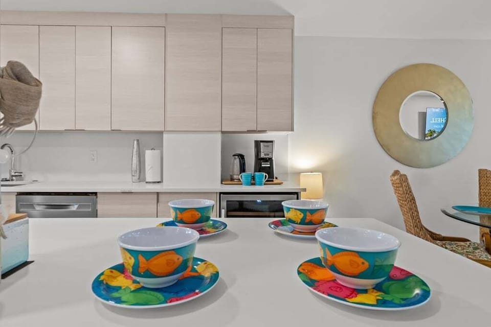 A bright, open kitchen designed for both style and function, with seamless flow to the dining and living areas — all framed by stunning Gulf views.