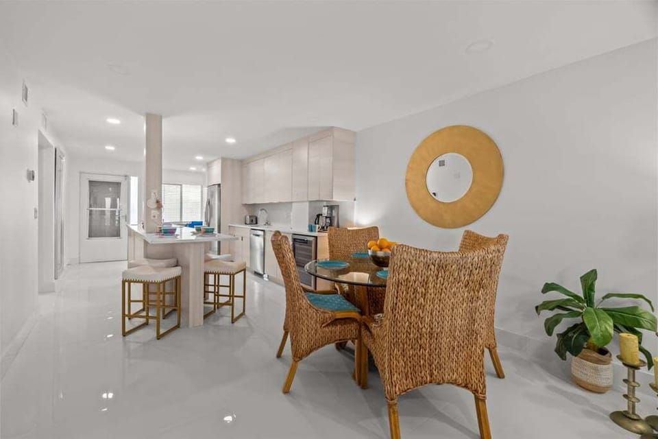 Experience effortless coastal living at Riviera Club 102 — an open-concept kitchen, dining, and living space seamlessly extends to the lanai, showcasing sweeping Gulf-front views.