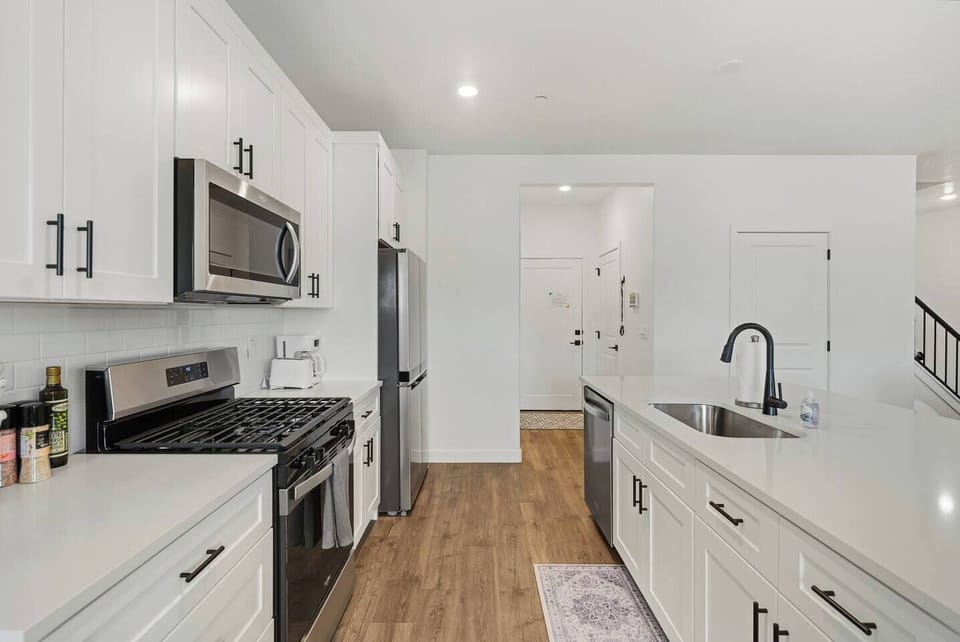 Full kitchen with stainless steel appliances and island.